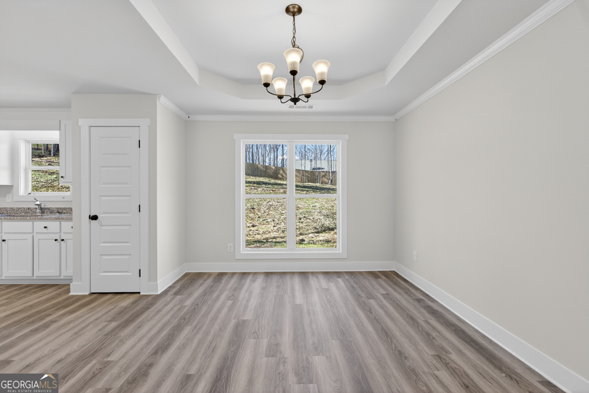 140 Chad Walk, Unit 57 Statham, GA 30666 - Photo 14 of 36 a view of an empty room with wooden floor and a window