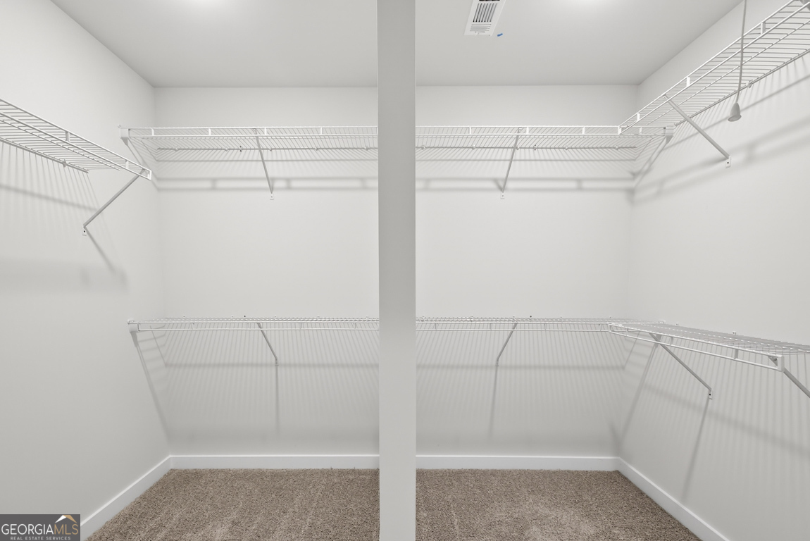 140 Chad Walk, Unit 57 Statham, GA 30666 - Photo 29 of 36 a view of a room with racks on the wall