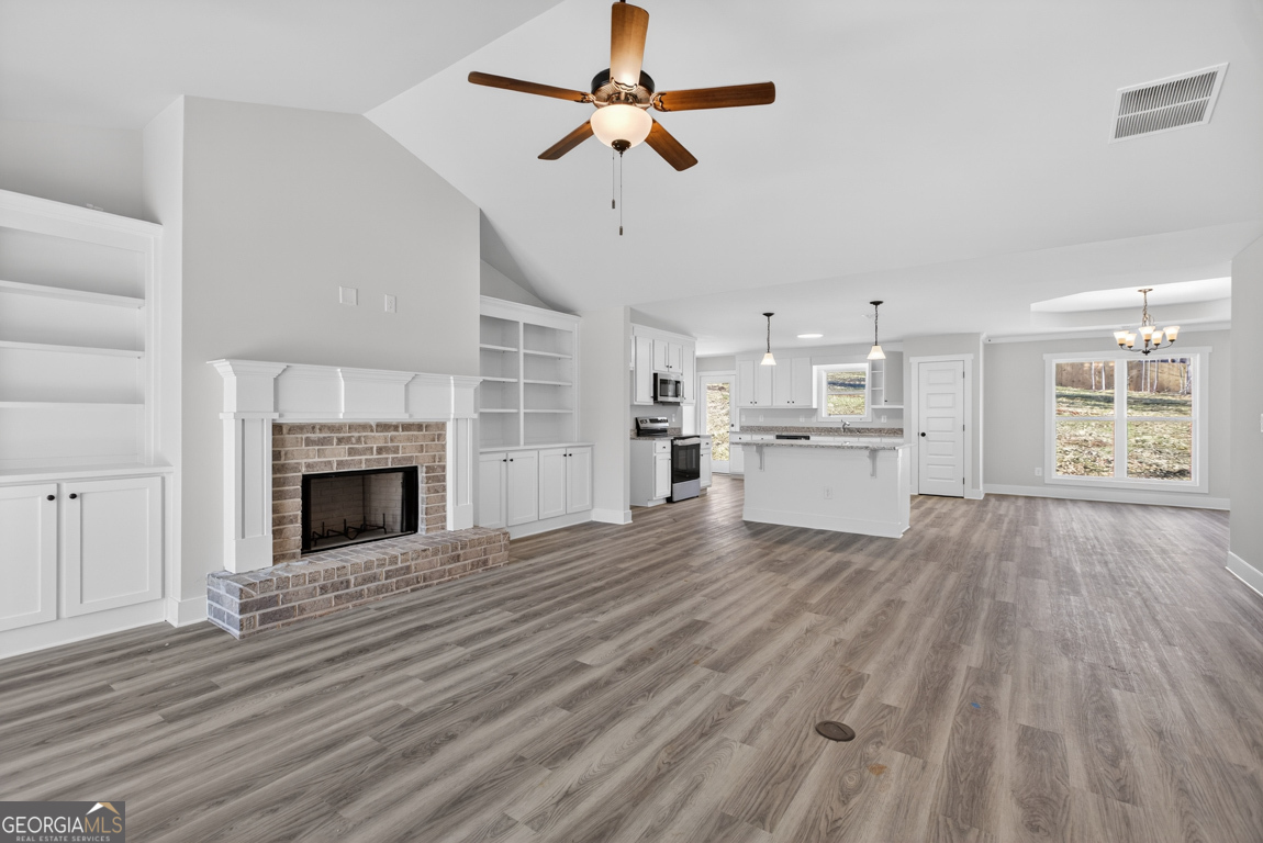 140 Chad Walk, Unit 57 Statham, GA 30666 - Photo 3 of 36 a view of a kitchen with furniture a ceiling fan and wooden floor
