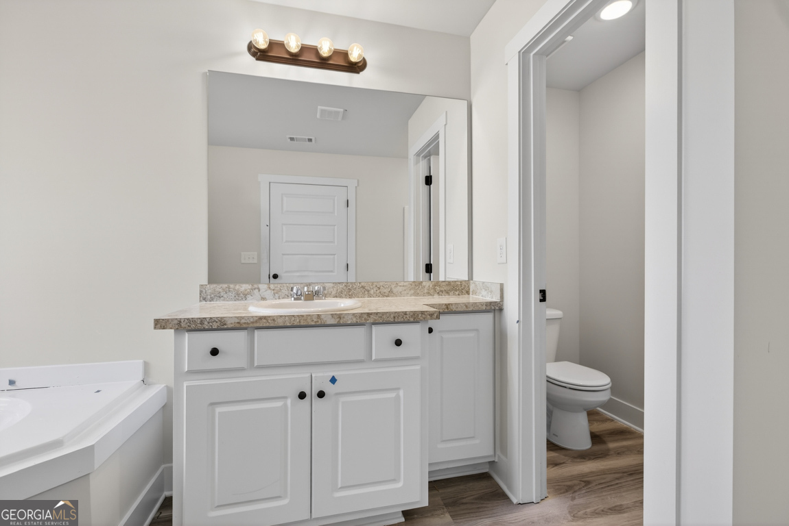140 Chad Walk, Unit 57 Statham, GA 30666 - Photo 34 of 36 a bathroom with a sink a toilet and a mirror