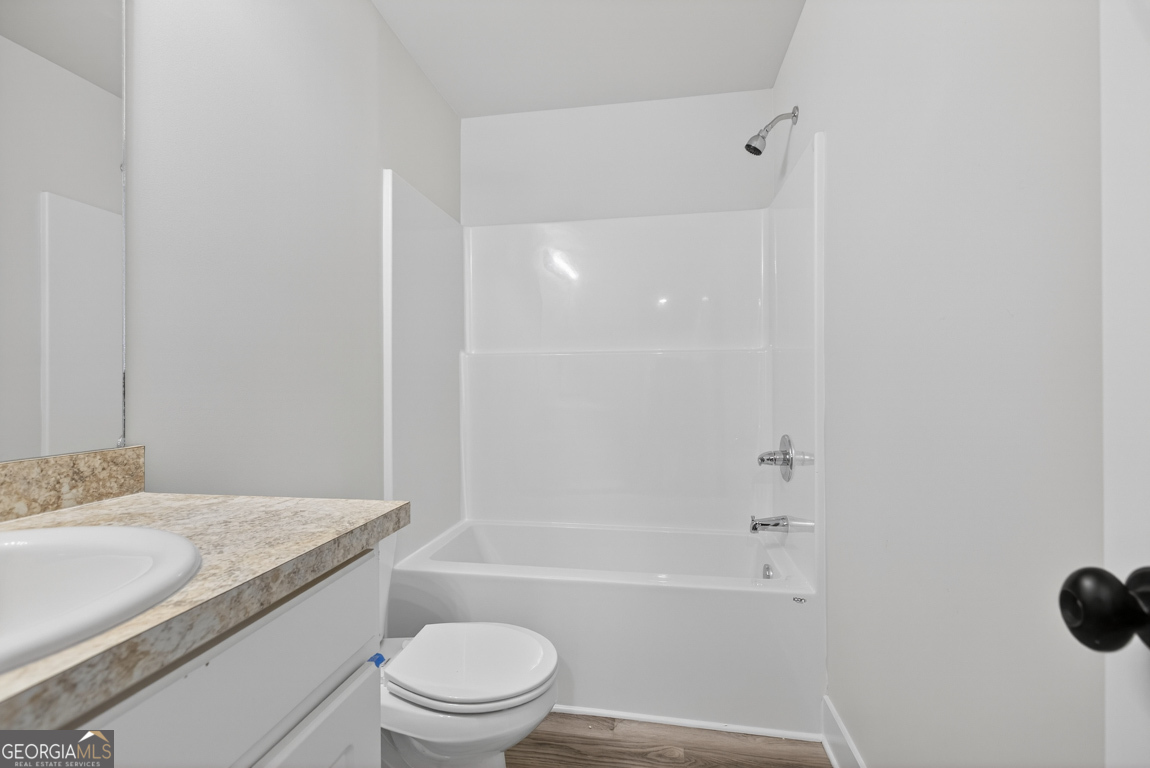 140 Chad Walk, Unit 57 Statham, GA 30666 - Photo 35 of 36 a bathroom with a granite countertop sink a toilet and shower
