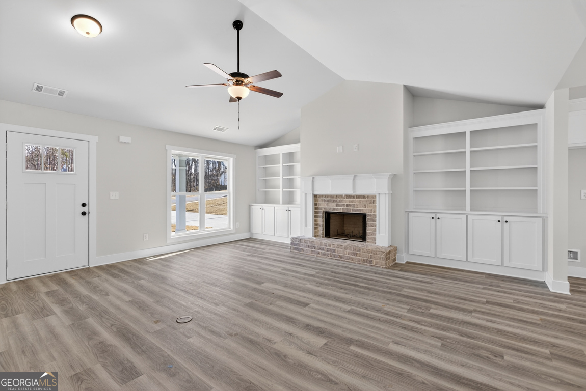140 Chad Walk, Unit 57 Statham, GA 30666 - Photo 5 of 36 a view of an empty room with a window and fireplace
