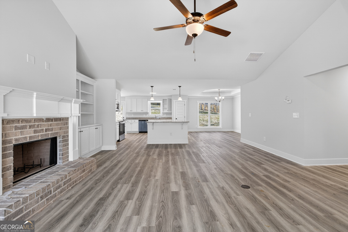 140 Chad Walk, Unit 57 Statham, GA 30666 - Photo 6 of 36 a view of a livingroom with wooden floor and a fireplace