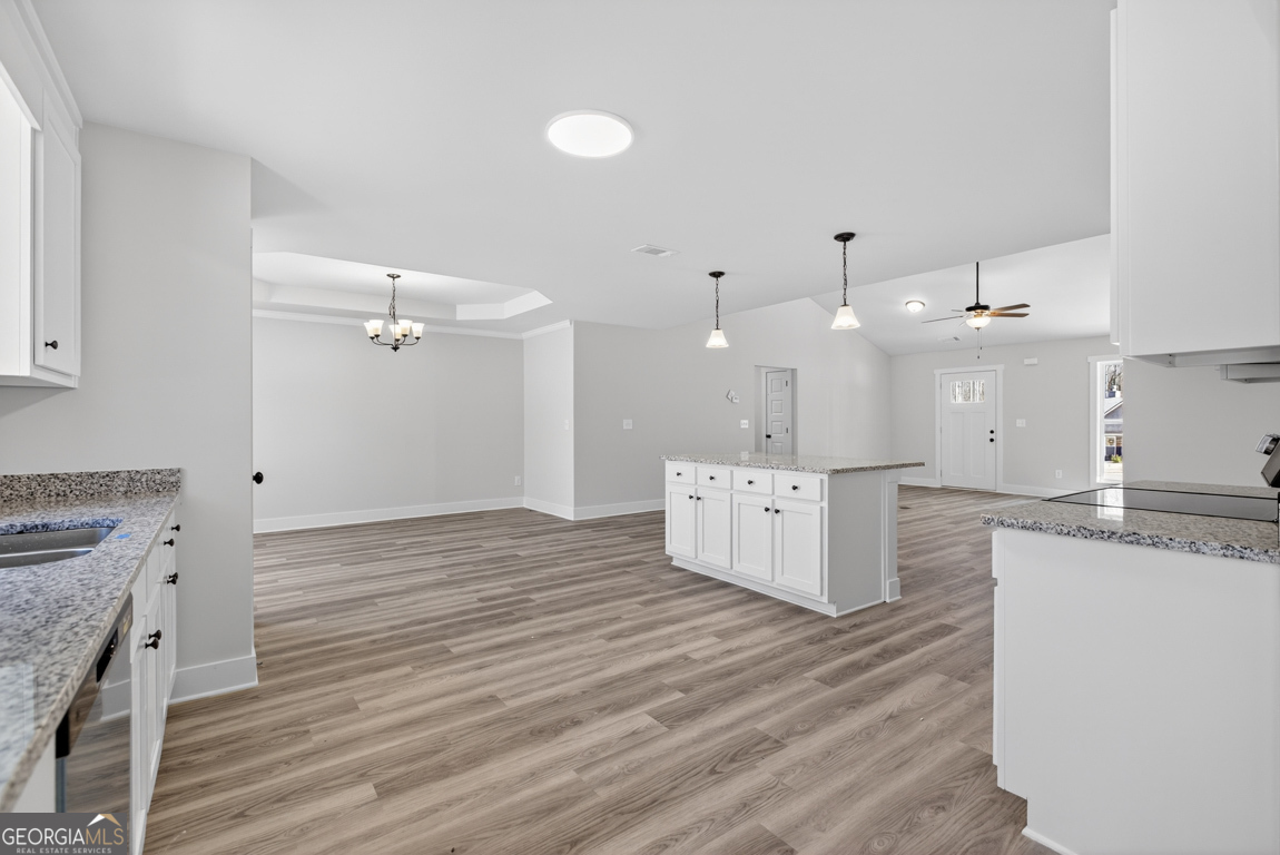 140 Chad Walk, Unit 57 Statham, GA 30666 - Photo 10 of 36 a large kitchen with stainless steel appliances granite countertop a large counter top a stove and a wooden floors