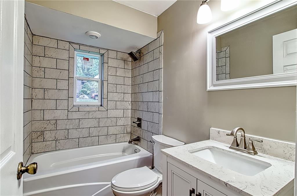 613 Virginia Avenue Rochester, PA 15074 - Photo 11 of 21 a bathroom with a sink mirror toilet and bathtub