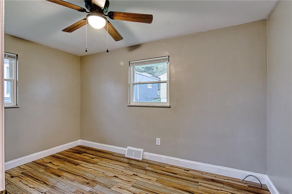 613 Virginia Avenue Rochester, PA 15074 - Photo 13 of 21 a view of room with wooden floor and fan