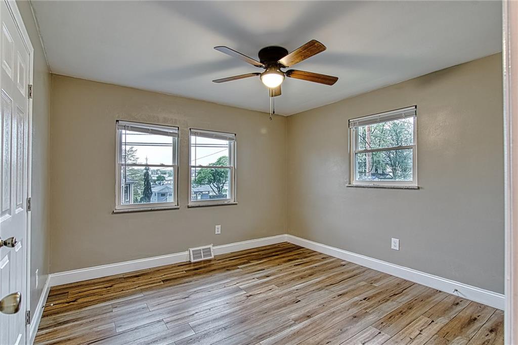 613 Virginia Avenue Rochester, PA 15074 - Photo 14 of 21 a view of empty room with wooden floor and fan