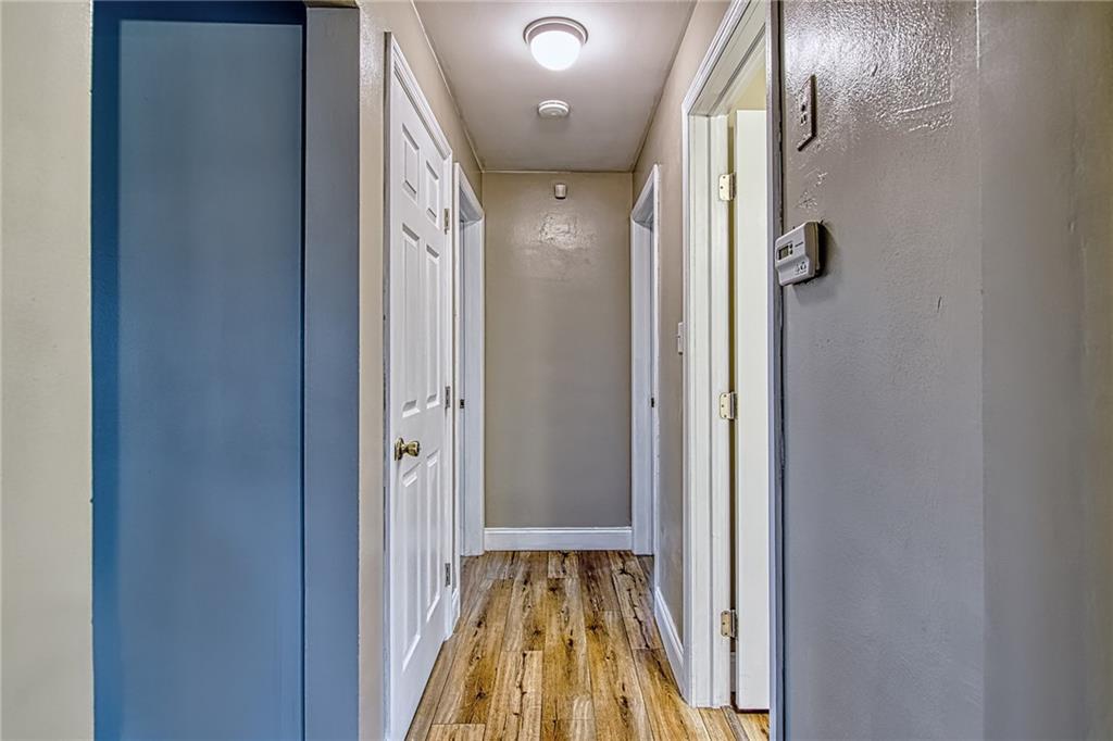 613 Virginia Avenue Rochester, PA 15074 - Photo 16 of 21 a view of a hallway with wooden floor and staircase