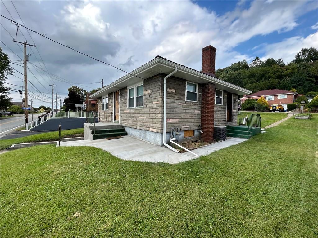 613 Virginia Avenue Rochester, PA 15074 - Photo 3 of 21 a view of a house with a yard patio and fire pit