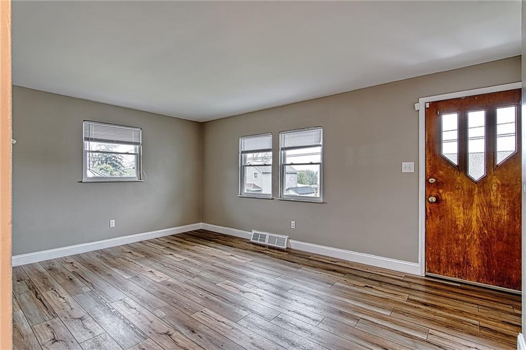 613 Virginia Avenue Rochester, PA 15074 - Photo 10 of 21 a view of empty room with wooden floor and fan