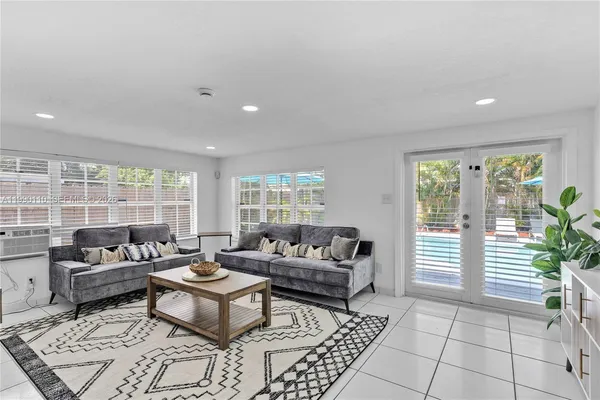 a living room with furniture a rug and a flat screen tv