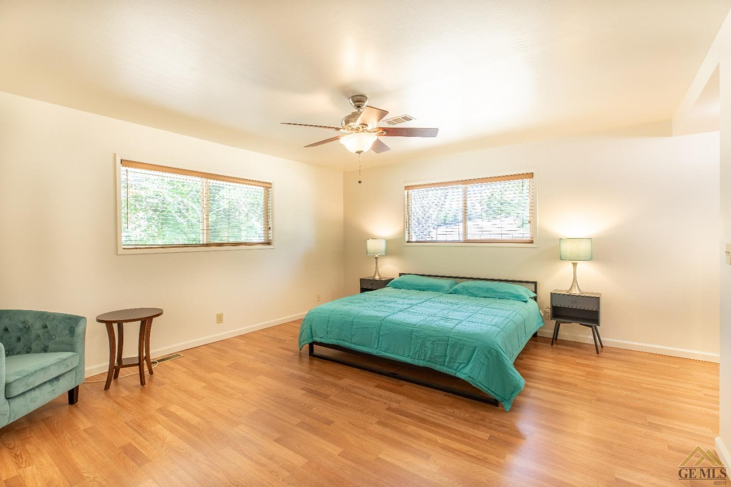 Undisclosed Address Caliente, CA 93518 - Photo 38 of 59 a bedroom with a bed chandelier and a window