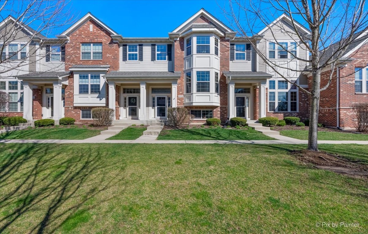 a front view of a house with a yard