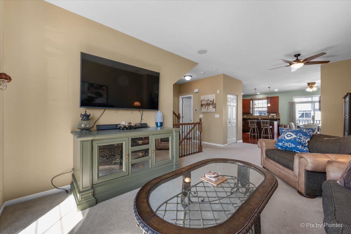N079 Vermont Court Winfield, IL 60190 - Photo 6 of 33 a living room with furniture a flat screen tv and kitchen view