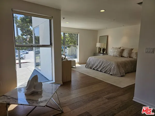 a living room with a bed furniture and a window