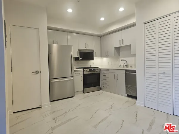 a kitchen with a refrigerator a sink and a stove