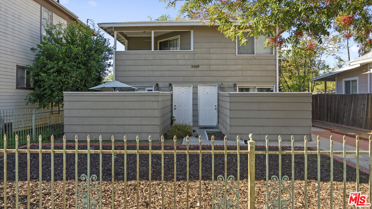 3469 Lime Street Riverside, CA 92501 - Photo 2 of 9 a view of a house with wooden fence