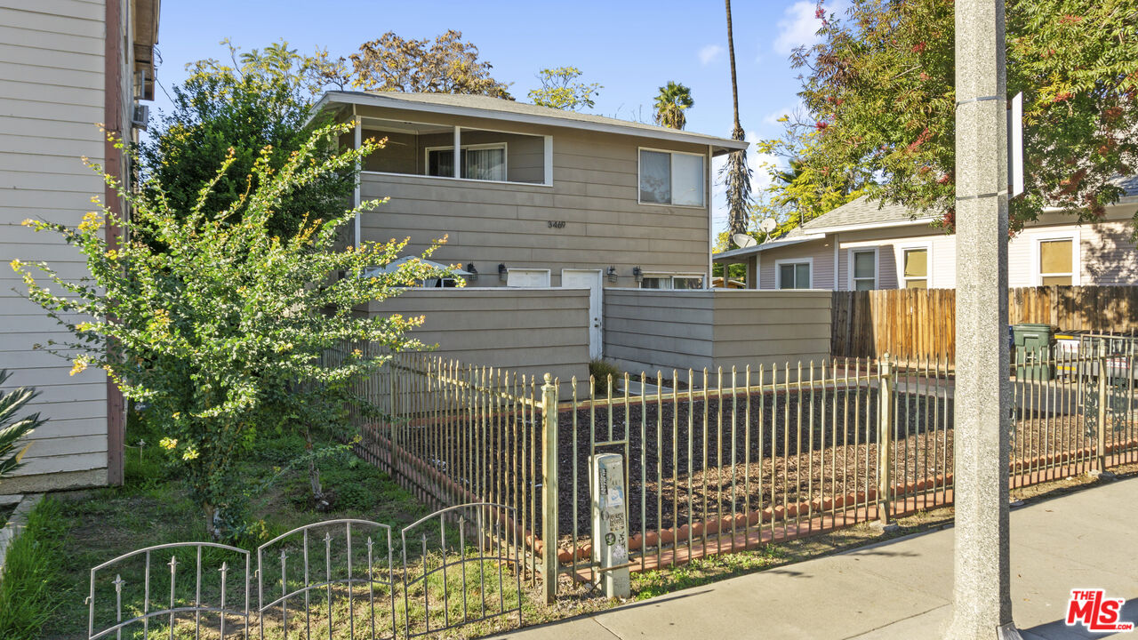 3469 Lime Street Riverside, CA 92501 - Photo 5 of 8 a front view of a house with a fence