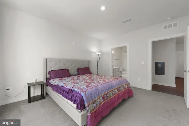 a bedroom with a bed closet and window