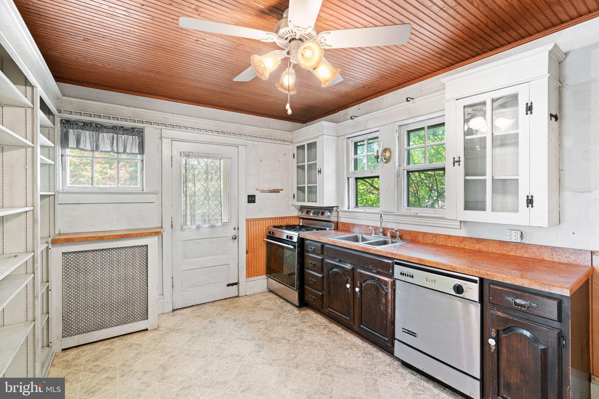 404 Grove Street Haddonfield, NJ 08033 - Photo 12 of 30 a large kitchen with kitchen island a large window and stainless steel appliances