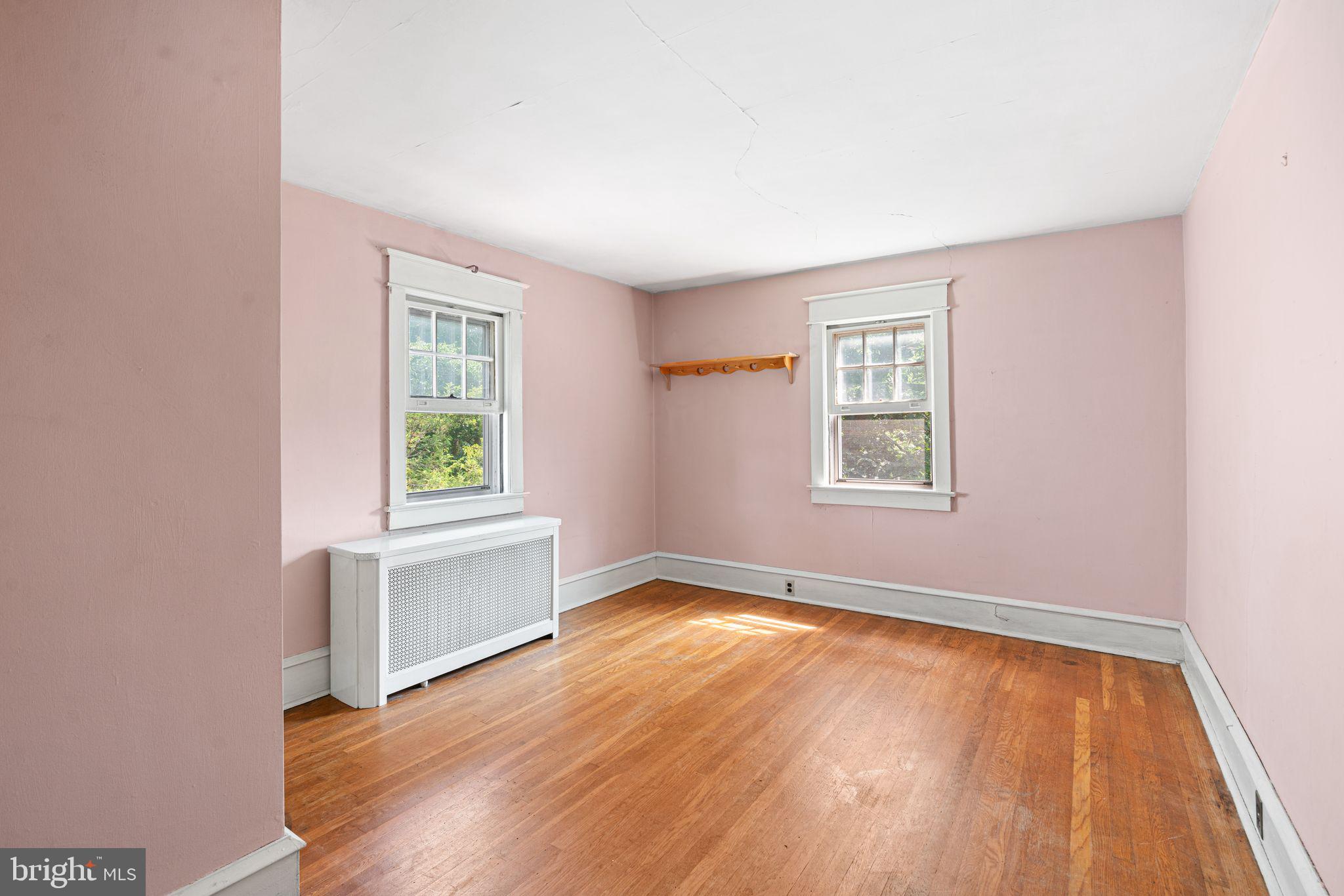 404 Grove Street Haddonfield, NJ 08033 - Photo 21 of 30 an empty room with wooden floor and windows
