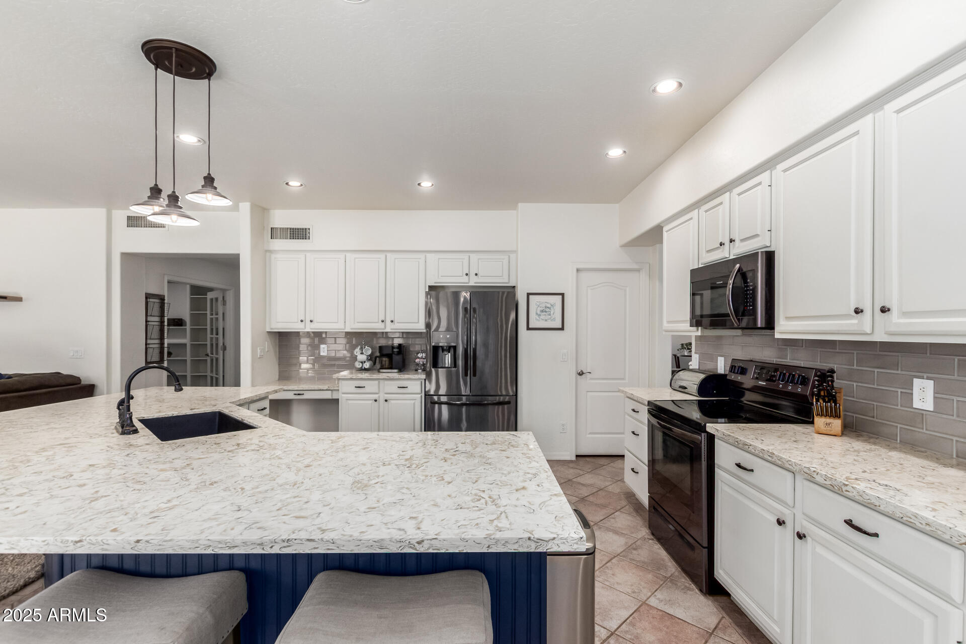 2859 East Millbrae Lane Gilbert, AZ 85234 - Photo 11 of 42 a kitchen with stainless steel appliances granite countertop a sink counter space and cabinets