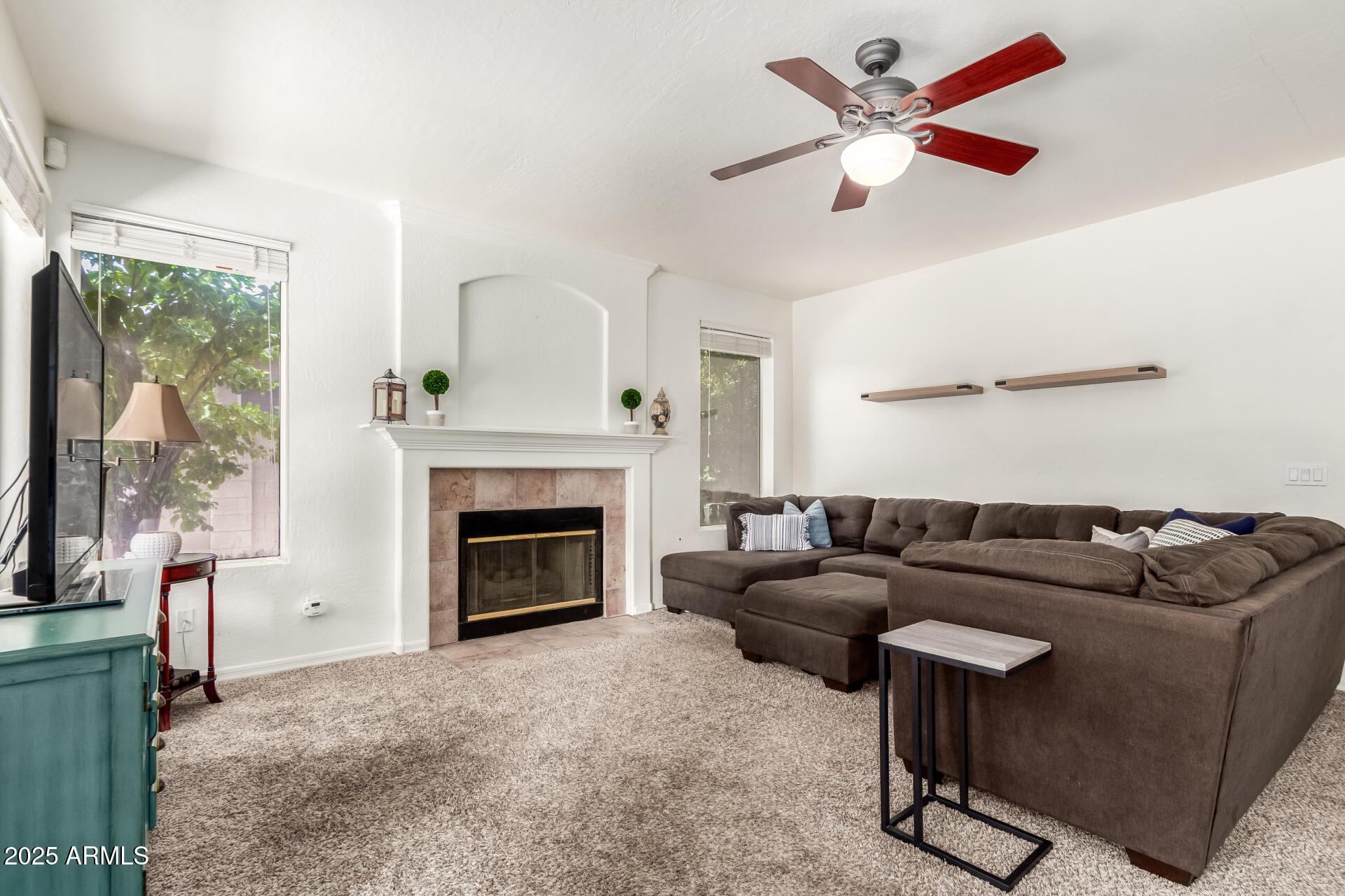 2859 East Millbrae Lane Gilbert, AZ 85234 - Photo 16 of 42 a living room with furniture and a fireplace