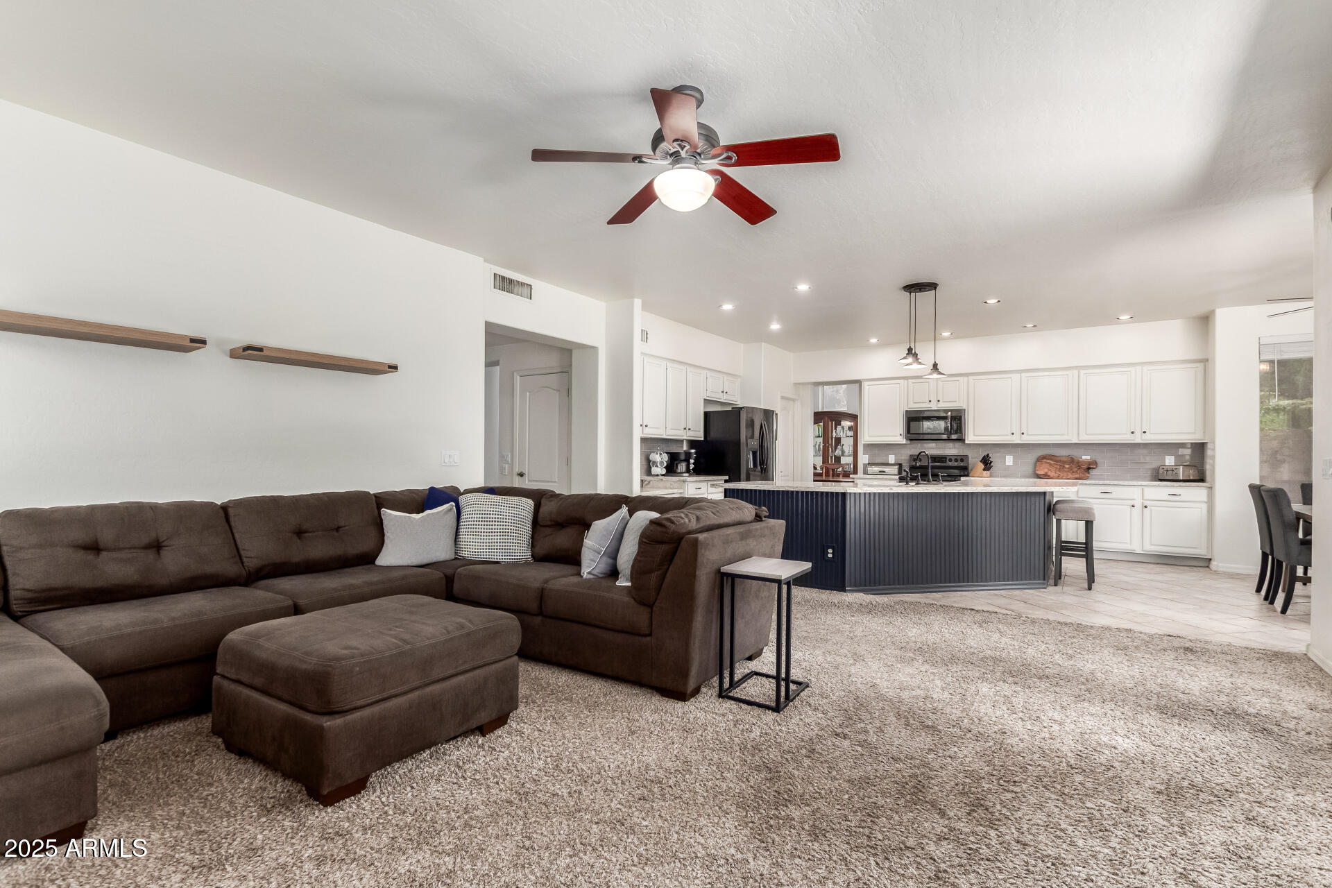 2859 East Millbrae Lane Gilbert, AZ 85234 - Photo 17 of 42 a living room with furniture and kitchen view