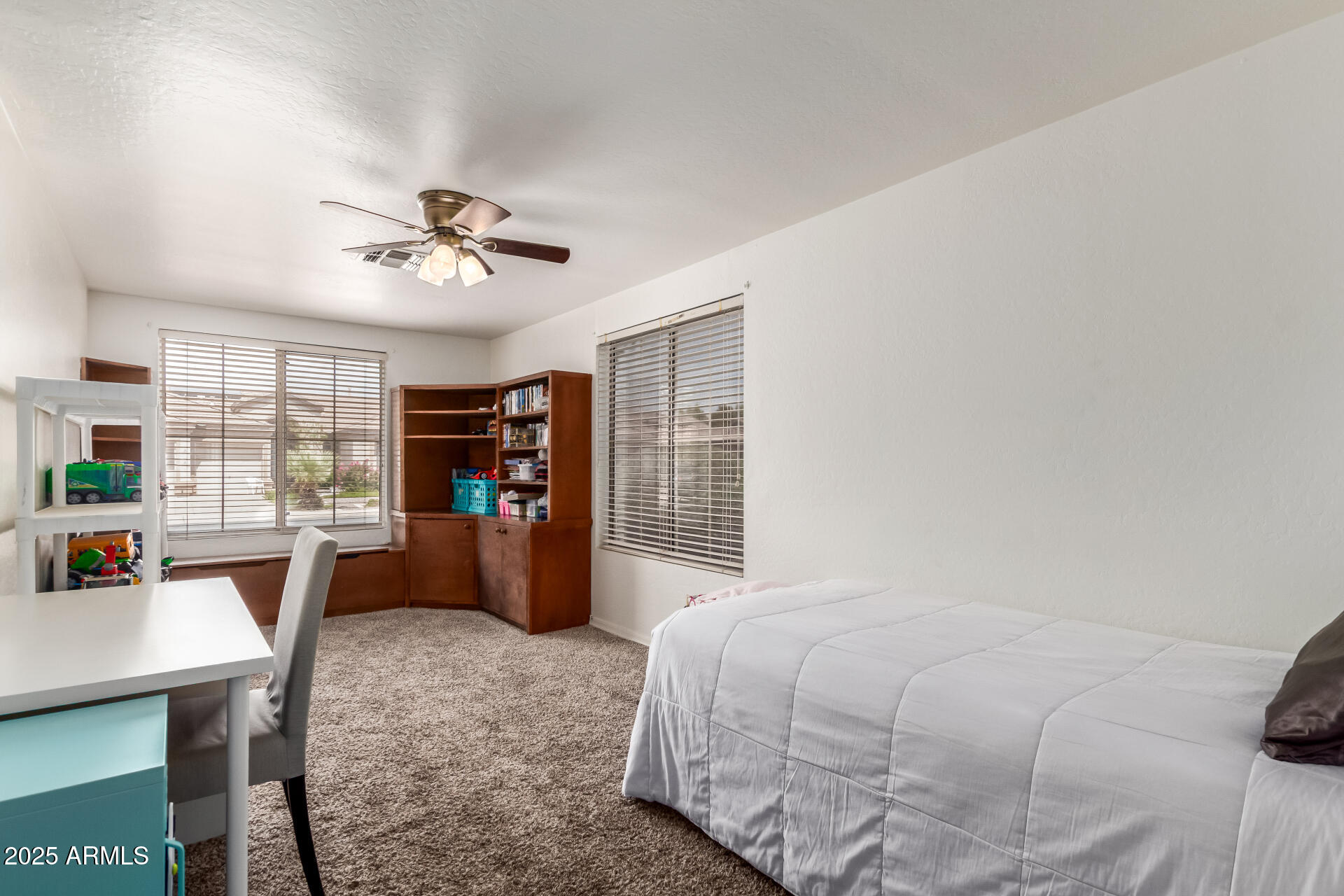 2859 East Millbrae Lane Gilbert, AZ 85234 - Photo 22 of 42 a bedroom with a large bed a chandelier and a window