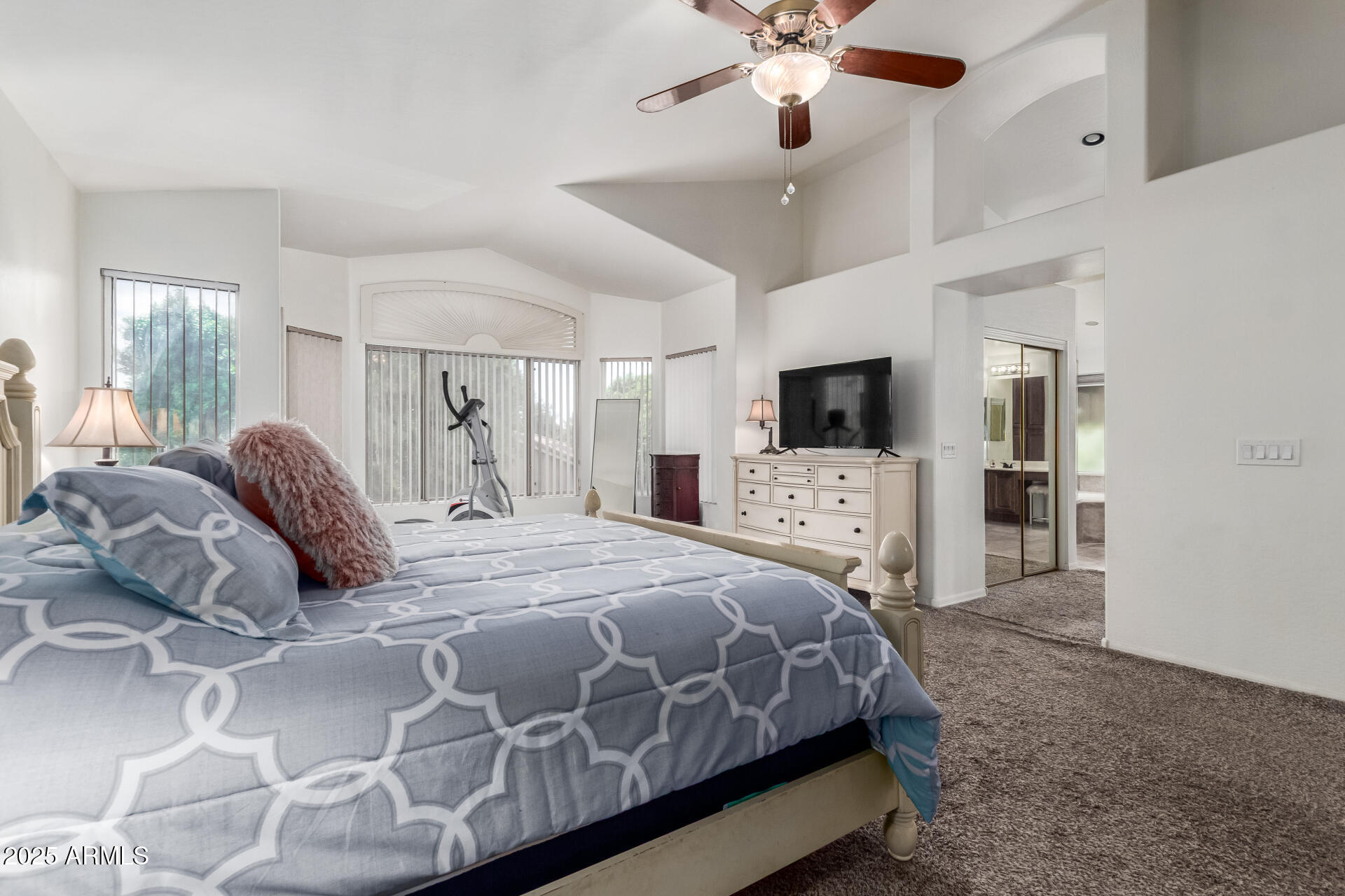 2859 East Millbrae Lane Gilbert, AZ 85234 - Photo 24 of 42 a bedroom with a large bed and a flat tv screen