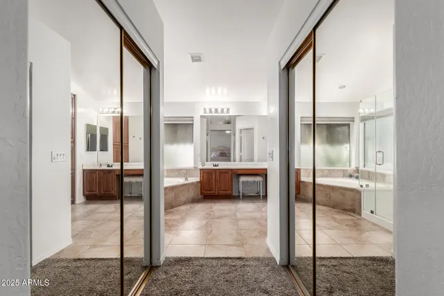 a bathroom with a tub mirror and shower