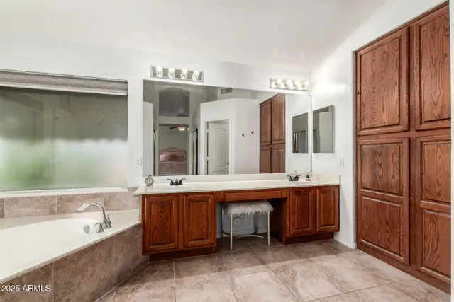 a large bathroom with a large tub and sink