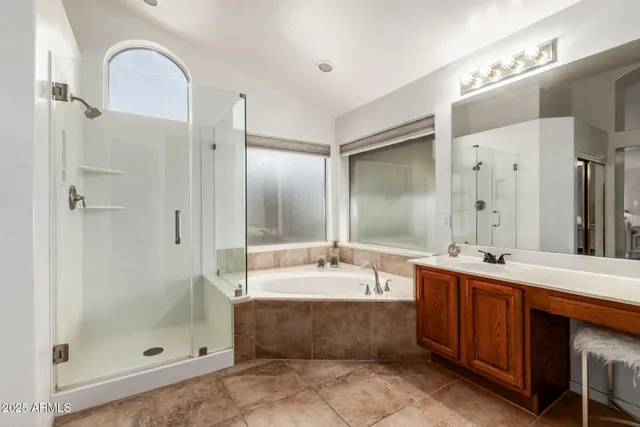 a bathroom with a double vanity sink mirror and shower