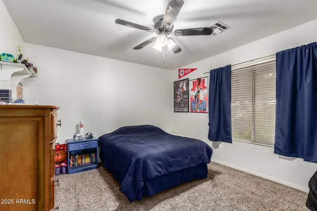 a bedroom with a bed dresser and a baby crib
