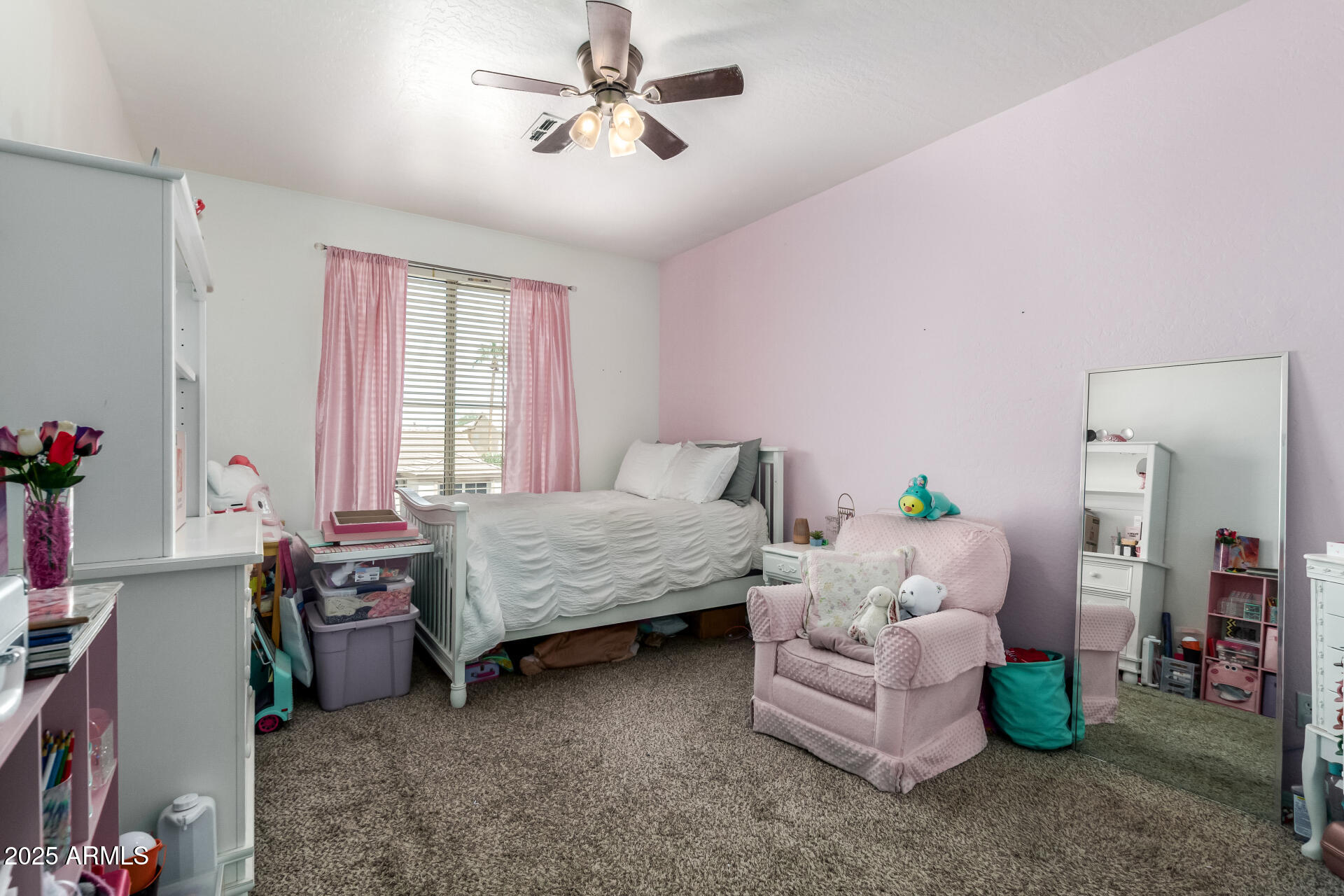 2859 East Millbrae Lane Gilbert, AZ 85234 - Photo 31 of 42 a bedroom with a bed a chandelier and a couch