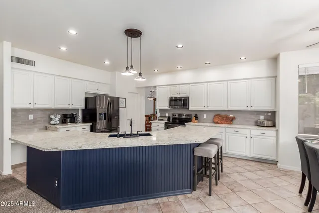 a kitchen with a sink a stove a refrigerator and cabinets