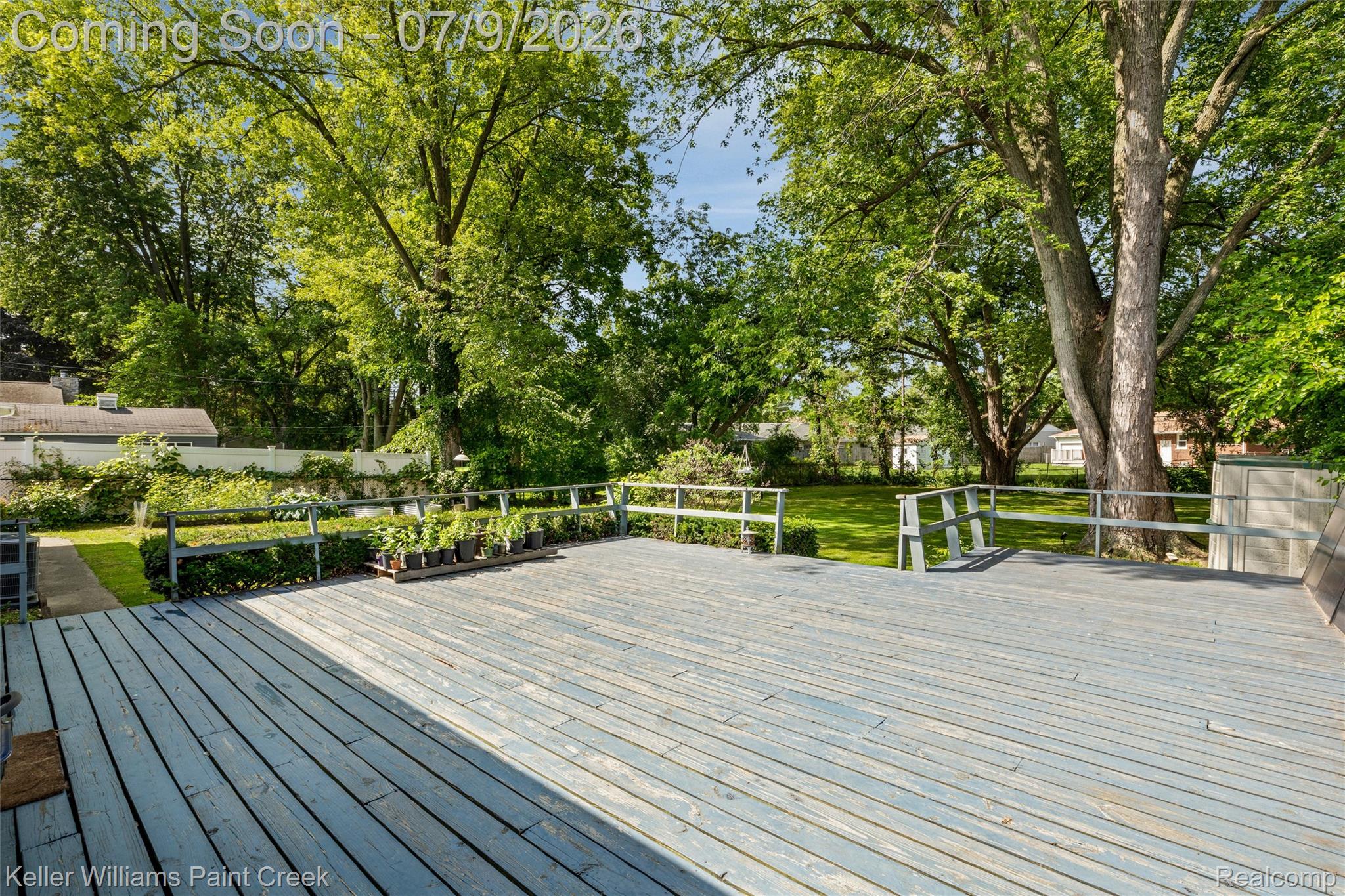 2731 Crooks Road Royal Oak, MI 48073 - Photo 33 of 34 Expansive wood deck with painted finish, featuring a perimeter railing and stairs to the lawn