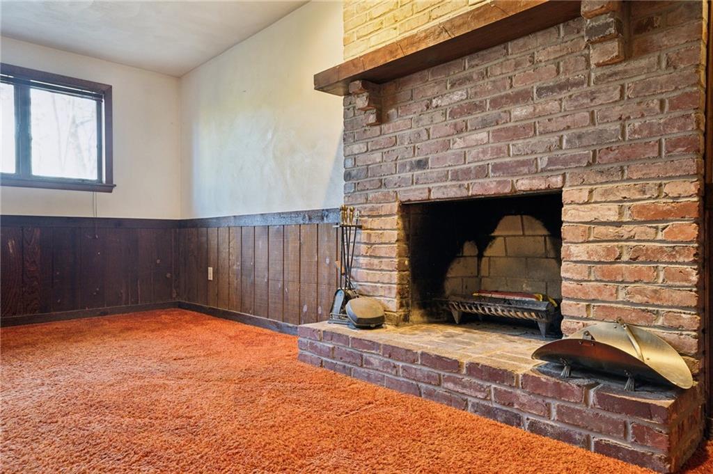 6149 Baker School Road Trafford, PA 15085 - Photo 20 of 30 a view of an empty room with wooden floor and a fireplace