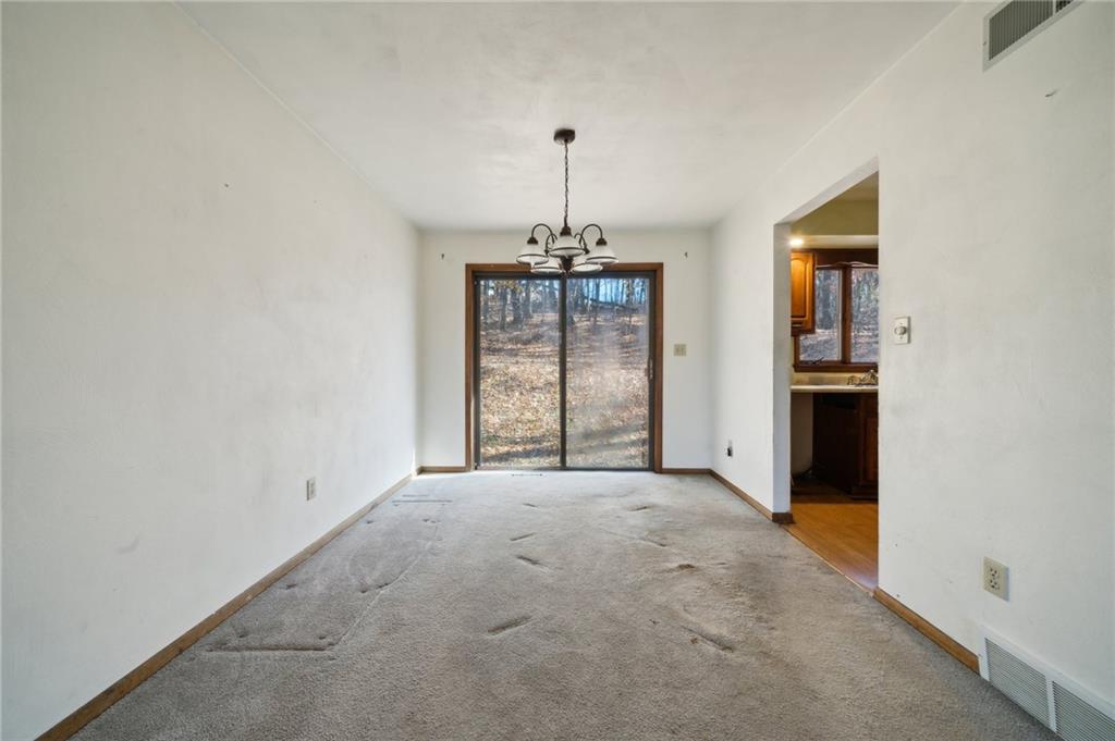 6149 Baker School Road Trafford, PA 15085 - Photo 7 of 30 an empty room with windows and cabinet