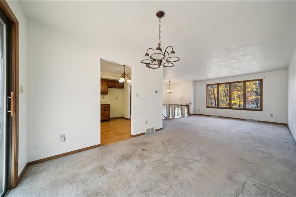 6149 Baker School Road Trafford, PA 15085 - Photo 8 of 30 a view of a livingroom with a chandelier wooden floor and windows
