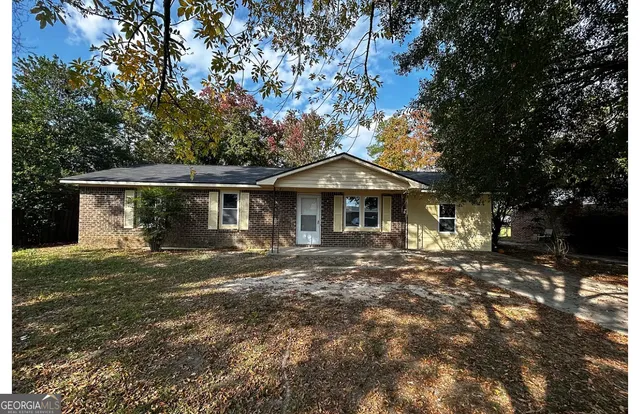 a front view of a house with a yard