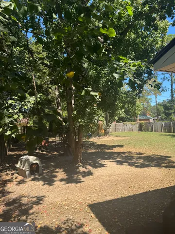 a view of a yard with large trees