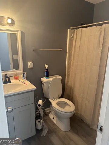 a bathroom with a sink a toilet and a mirror