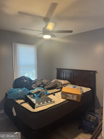 a bed sitting in a bedroom next to a window