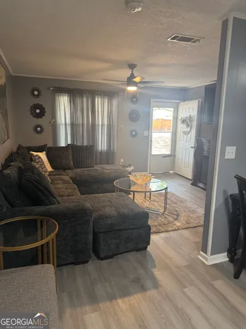 a living room with furniture and a chandelier