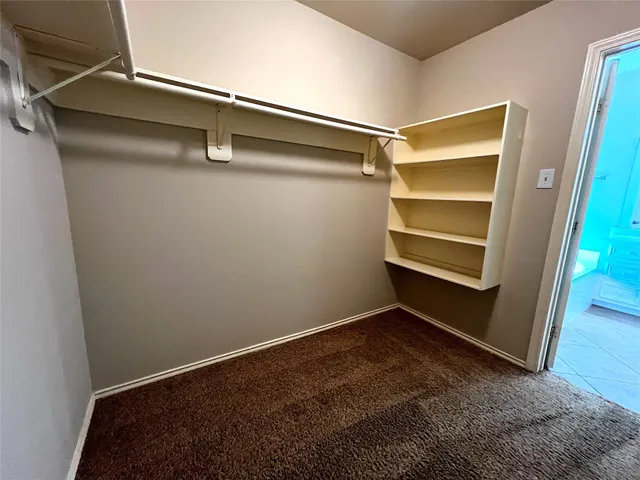 a view of an empty walk in closet