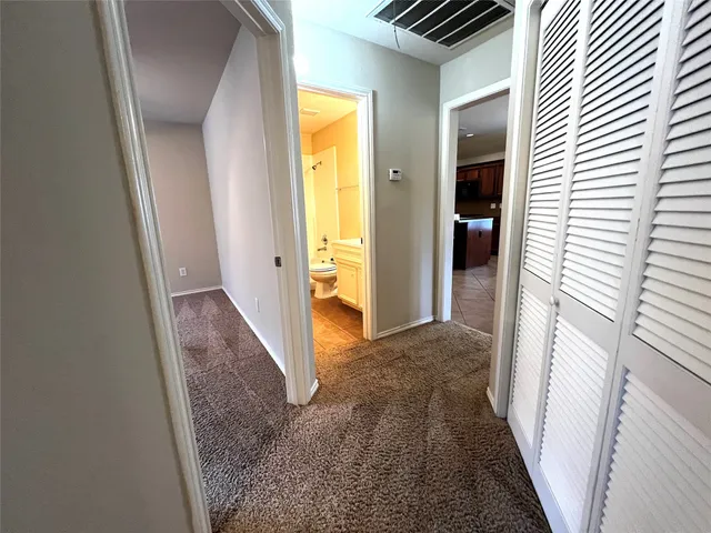 a view of hallway with wooden floor