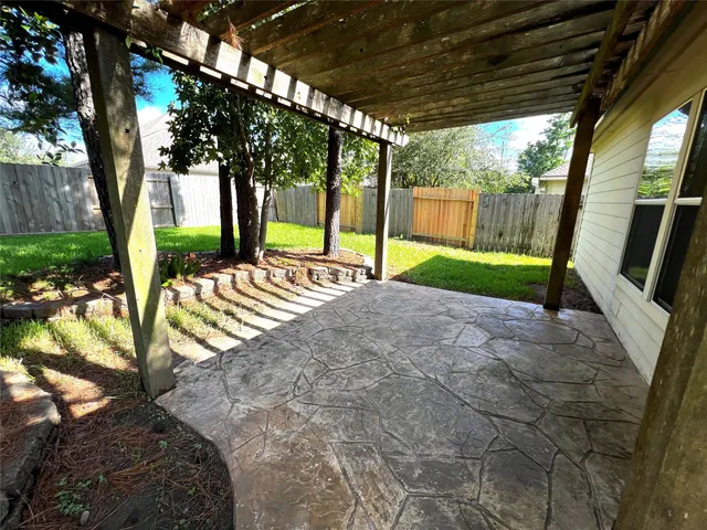 a view of a porch with furniture and a yard
