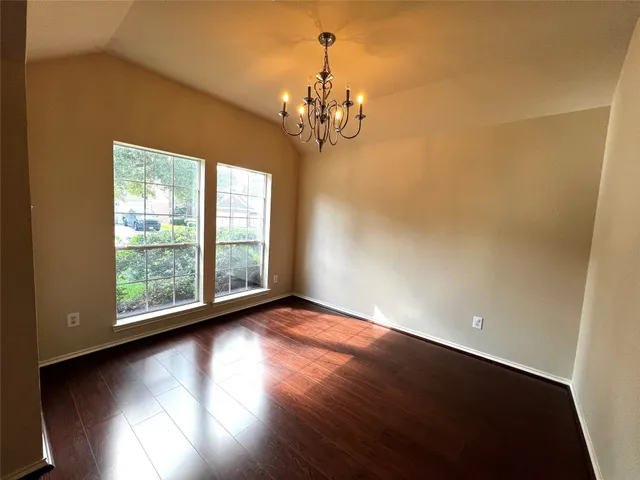 a view of a livingroom with a window and wooden floor