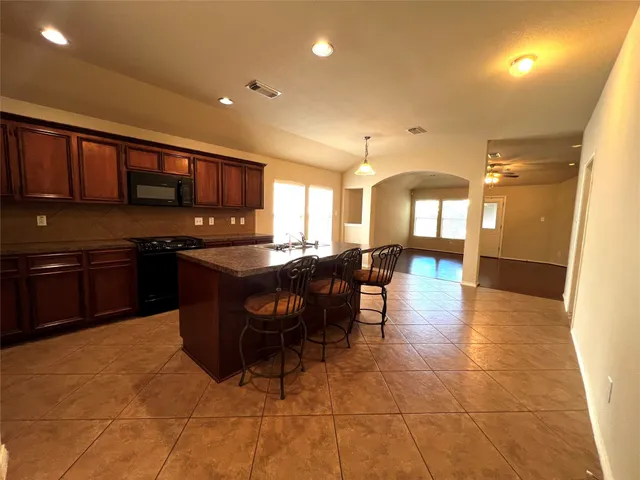 a kitchen with stainless steel appliances granite countertop a sink counter space and cabinets